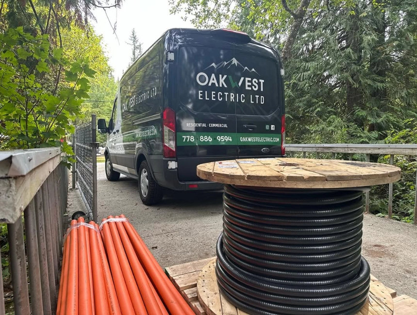 oakwest-electric-van-on-jobsite-wire-spool-orange-conduit