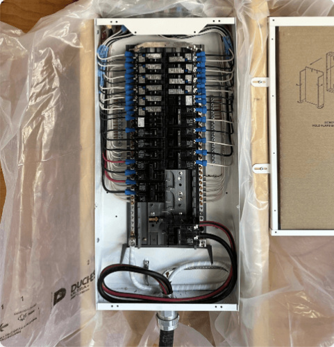 An open, newly installed electrical panel with organized wiring, showing what to expect from a 100-amp to 200-amp service upgrade.
