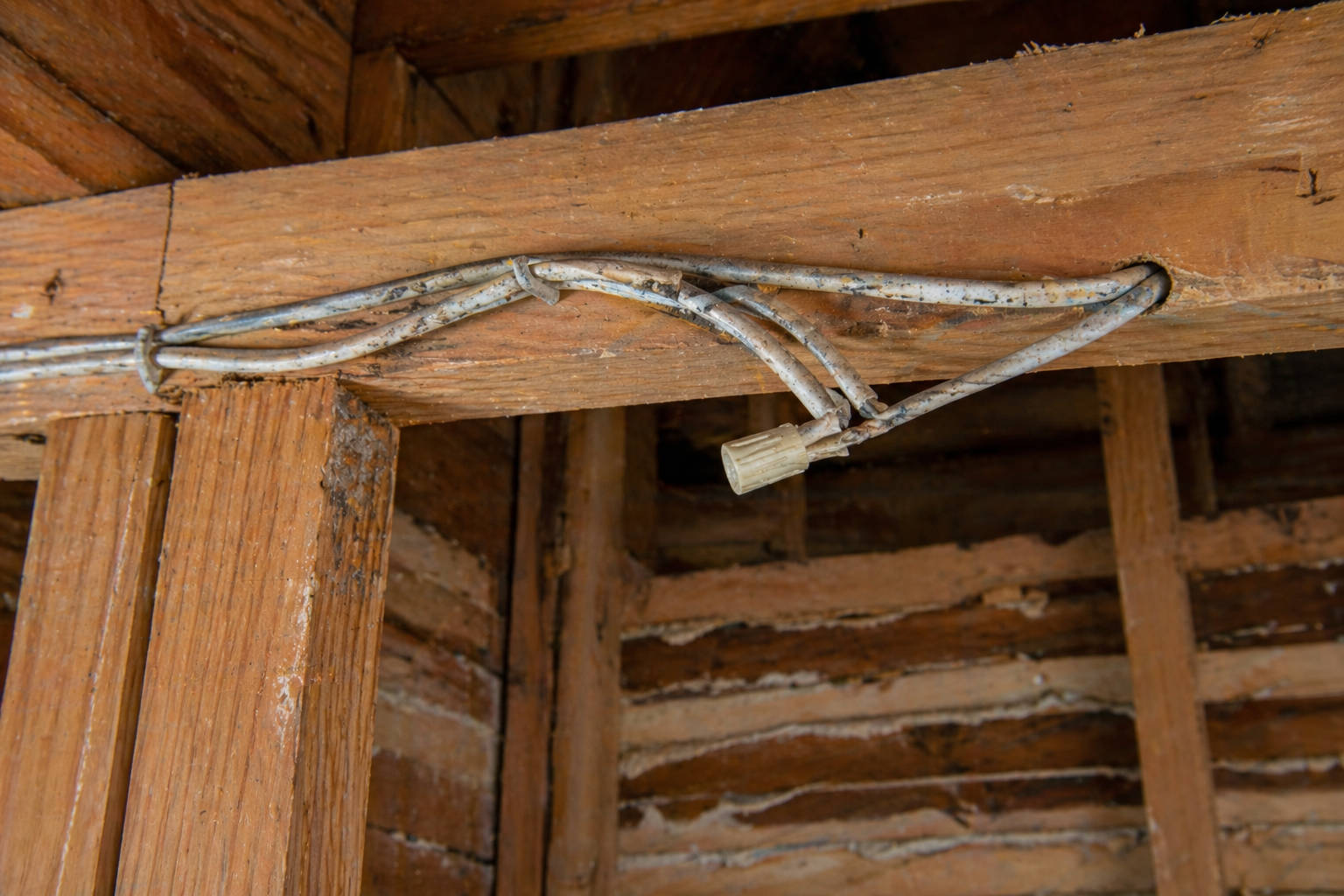 A close-up view of aging aluminum wiring connections in an older home, showing the condition of electrical systems that often require upgrades.
