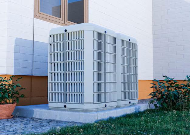 Two modern outdoor heat pump units installed on a concrete pad next to a residential home in Langley.