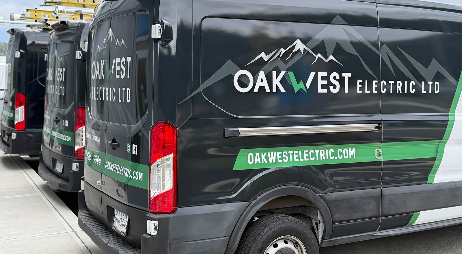 A fleet of branded Oakwest Electric service vans parked and ready to perform residential electrical work in Langley, BC.
